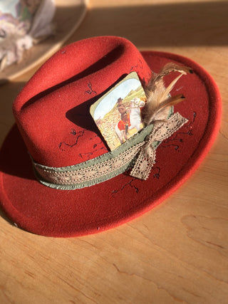 Crimson red hat with vintage litho card